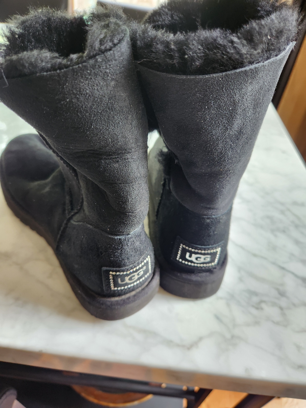 UGG Classic Short Black Shearling Boots with side crystal round embellishment.